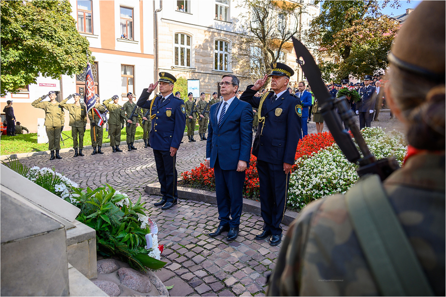 Prezydent Roman Ciepiela w asyście strażników miejskich składa kwiaty przed Grobem Nieznanego Żołnierza